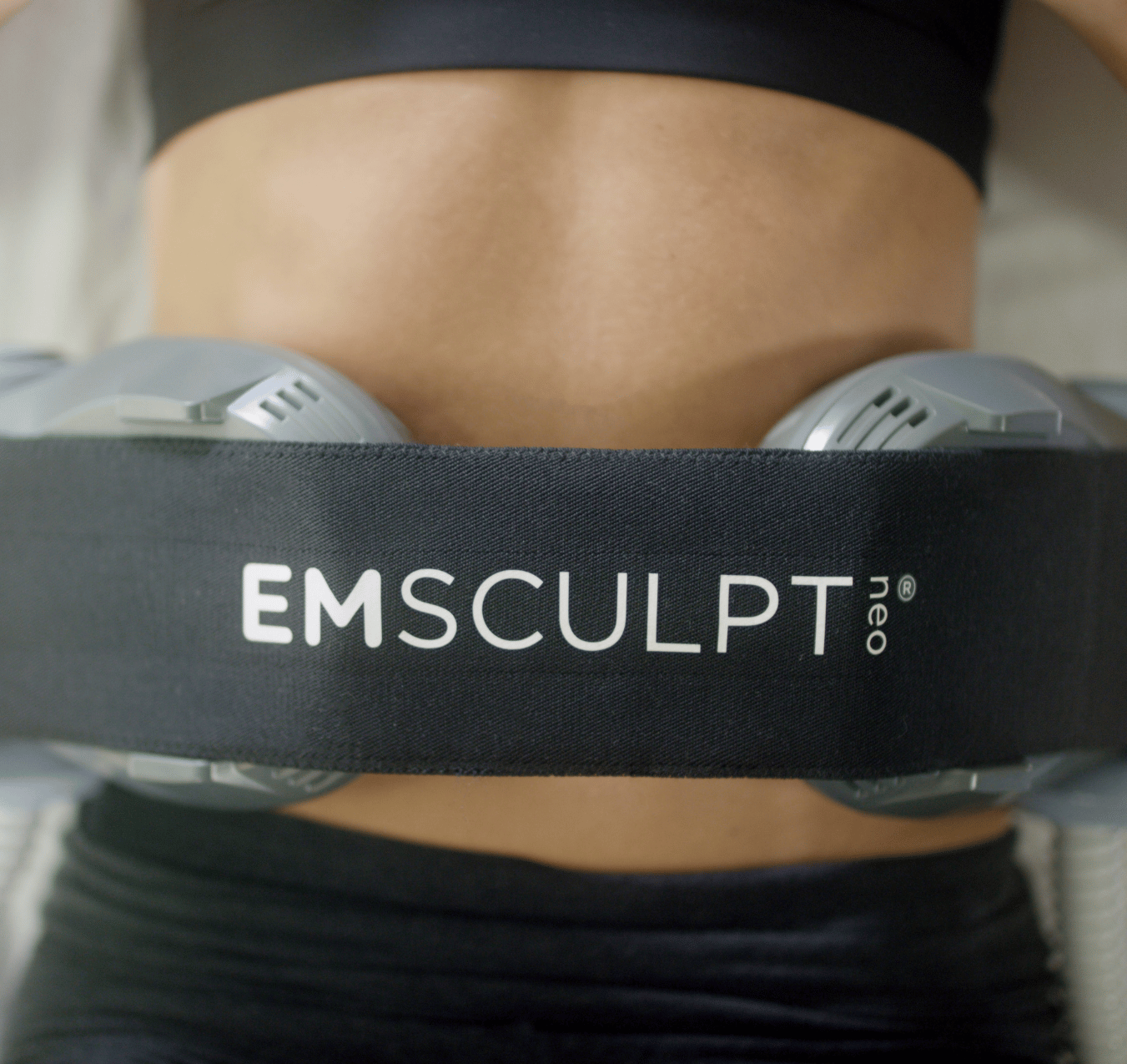 EMSCULPT Neo attached to abdominal muscles.